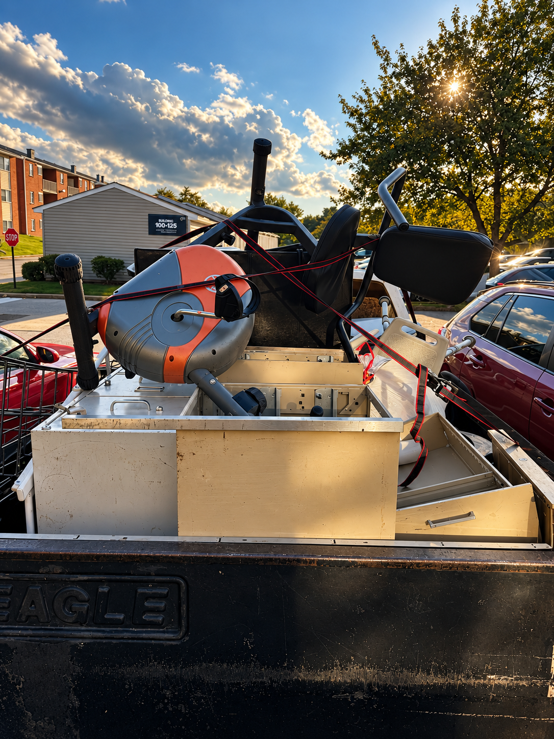 Pickup truck loaded and strapped with furniture and gym equipment